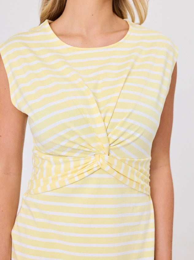 Woman wearing a coastal living inspired yellow striped cotton dress by Navy & Co, standing front-facing in natural light