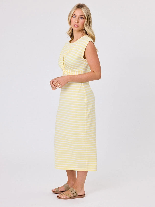 Woman wearing a coastal living inspired yellow striped cotton dress by Navy & Co, standing front-facing in natural light