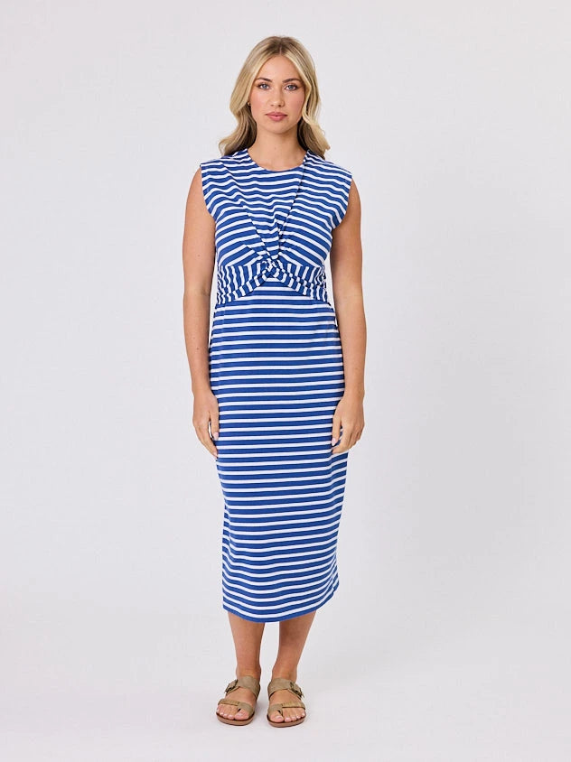 Woman wearing a coastal living inspired ocean blue striped cotton dress by Navy & Co, standing front-facing in natural light