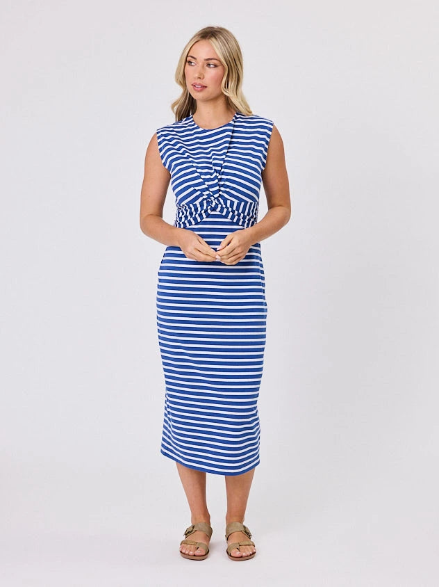 Woman wearing a coastal living inspired ocean blue striped cotton dress by Navy & Co, standing front-facing in natural light