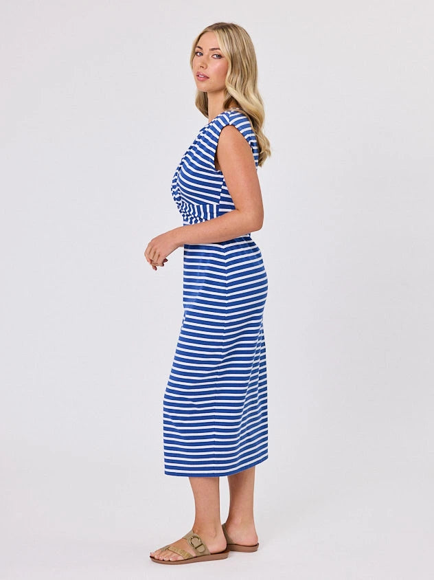 Woman wearing a coastal living inspired ocean blue striped cotton dress by Navy & Co, standing front-facing in natural light
