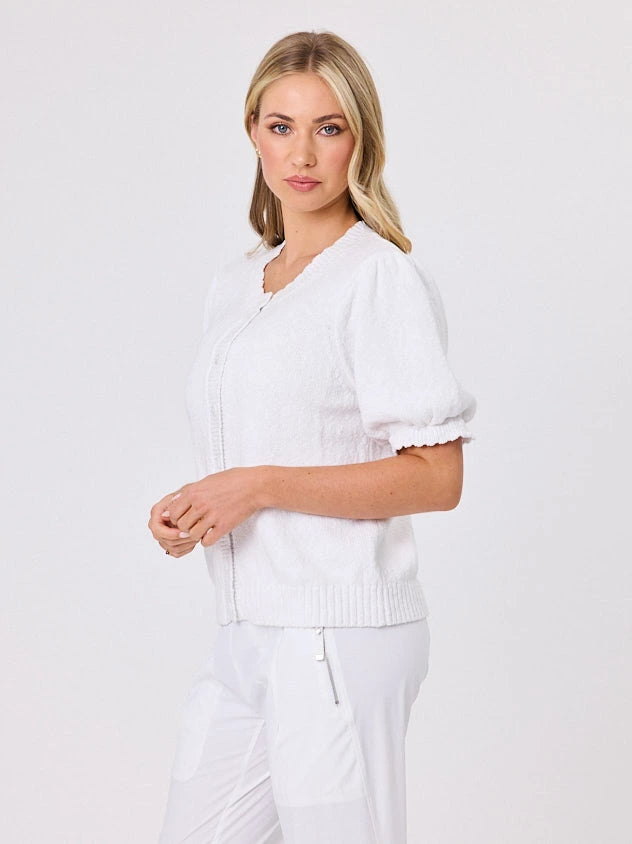 Woman wearing a white lightweight knit cotton cardi top by Navy & Co fashion brand, standing front-facing in natural light