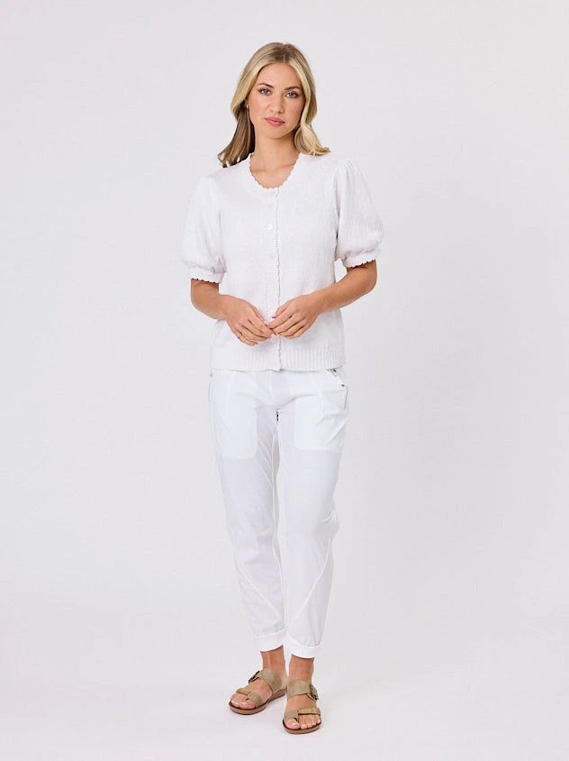 Woman wearing a white lightweight knit cotton cardi top by Navy & Co fashion brand, standing front-facing in natural light