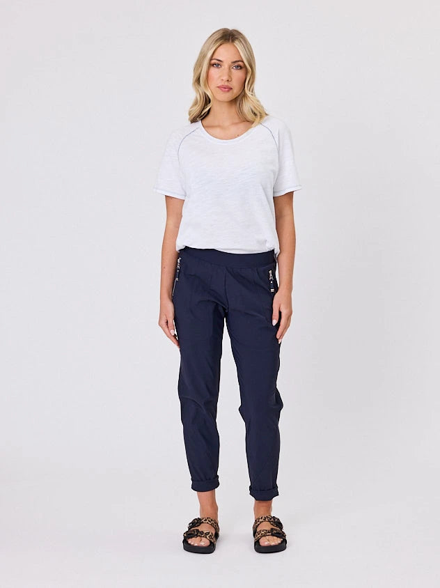 Woman standing front-on in studio light wearing navy crew pocket pants by Navy & Co nz fashion brand 