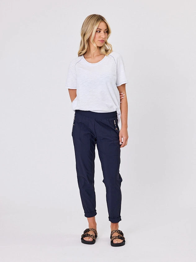 Woman standing front-on in studio light wearing navy crew pocket pants by Navy & Co nz fashion brand 