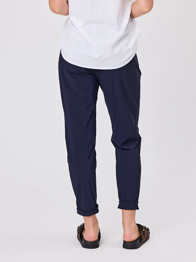 Woman standing front-on in studio light wearing navy crew pocket pants by Navy & Co nz fashion brand 