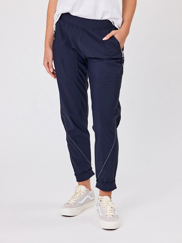 Woman standing front-on in studio light wearing navy crew pocket pants, with white stich by Navy & Co nz fashion brand 