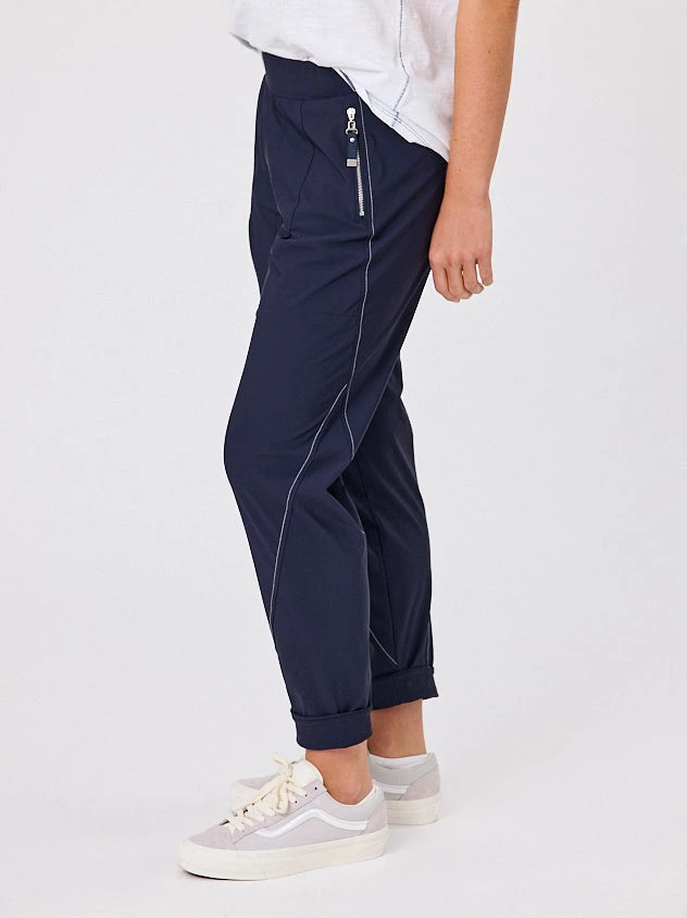 Woman standing front-on in studio light wearing navy crew pocket pants, with white stich by Navy & Co nz fashion brand 