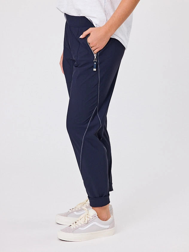 Woman standing front-on in studio light wearing navy crew pocket pants, with white stich by Navy & Co nz fashion brand 