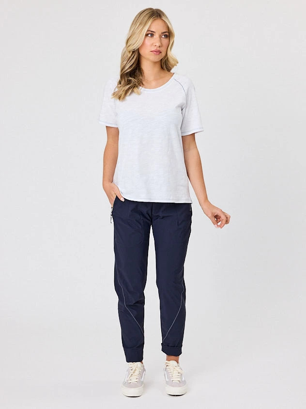 Woman standing front-on in studio light wearing navy crew pocket pants, with white stich by Navy & Co nz fashion brand 