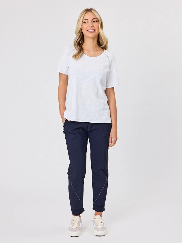 Woman standing front-on in studio light wearing navy crew pocket pants, with white stich by Navy & Co nz fashion brand 