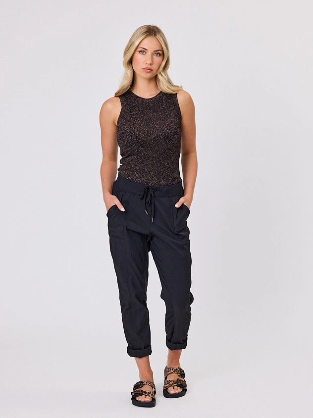 Woman standing front-on in studio light wearing black voyage crew pants, with white stich by Navy & Co nz fashion brand 