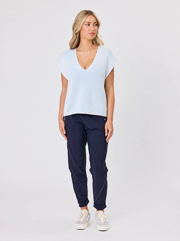 Woman standing front-on in studio light wearing white cotton ribbed top, by Navy & Co nz fashion brand 
