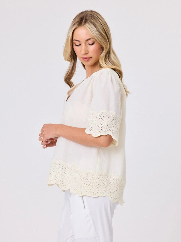 Woman standing front-on in studio light wearing lemon cotton top, by Navy & Co nz fashion brand 