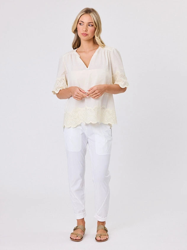 Woman standing front-on in studio light wearing lemon cotton top, by Navy & Co nz fashion brand 