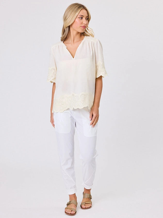 Woman standing front-on in studio light wearing lemon cotton top, by Navy & Co nz fashion brand 