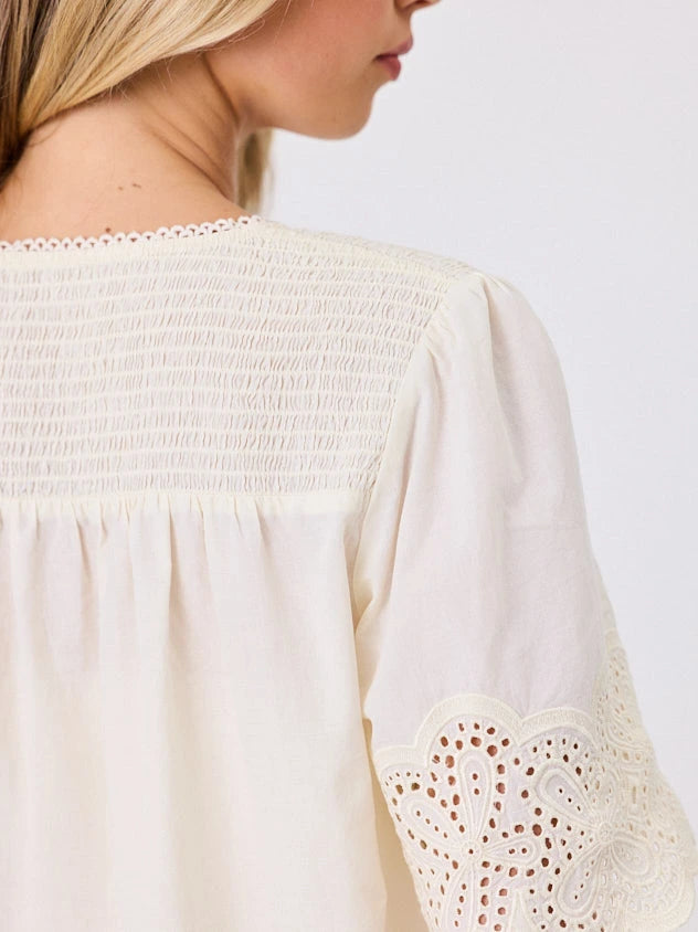 Close-up of a Woman standing front-on in studio light wearing lemon cotton top, by Navy & Co nz fashion brand 