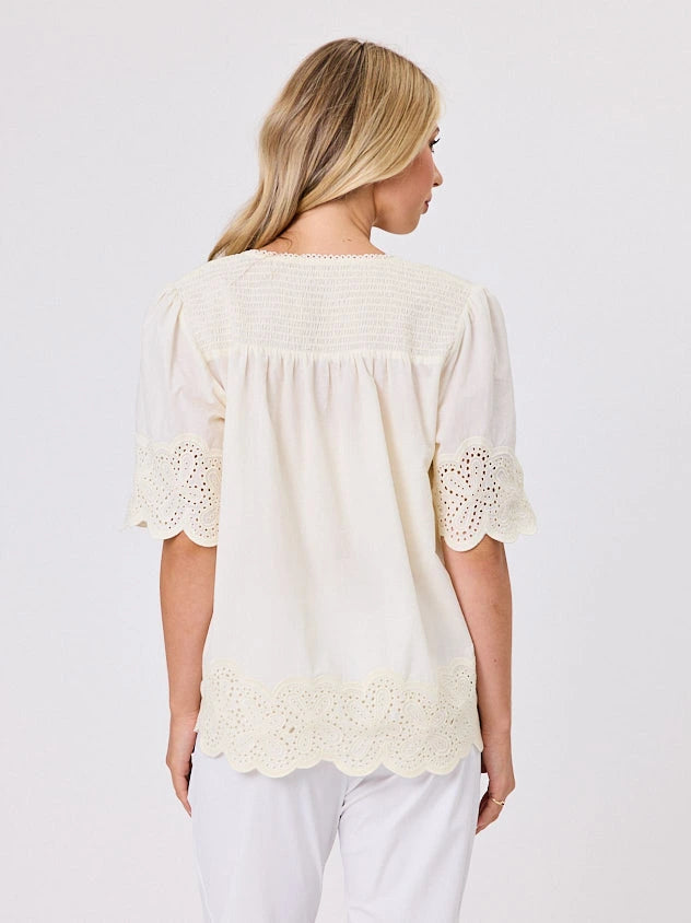 Woman standing front-on in studio light wearing lemon cotton top, by Navy & Co nz fashion brand 