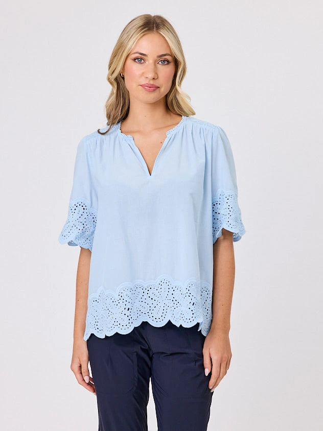 Woman standing front-on in studio light wearing pastel blue cotton top, by Navy & Co nz fashion brand 