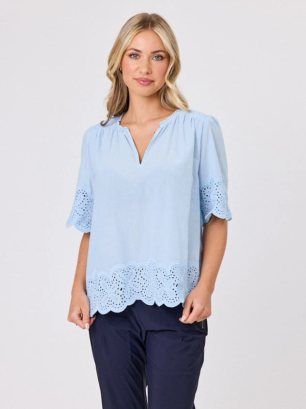 Woman standing front-on in studio light wearing pastel blue cotton top, by Navy & Co nz fashion brand 