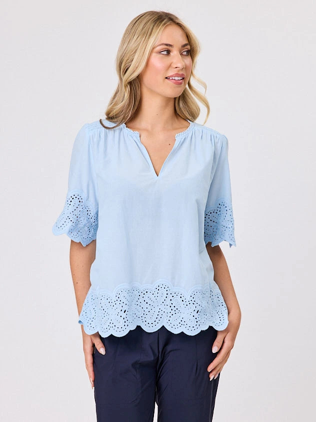 Woman standing front-on in studio light wearing pastel blue cotton top, by Navy & Co nz fashion brand 