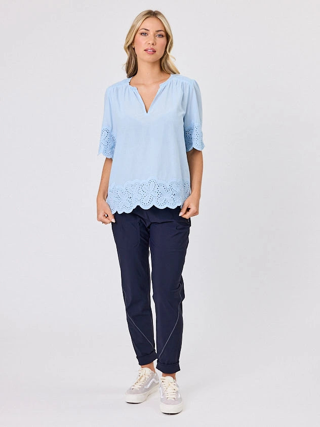Woman standing front-on in studio light wearing pastel blue cotton top, by Navy & Co nz fashion brand 