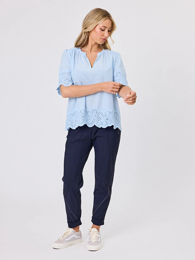 Woman standing front-on in studio light wearing pastel blue cotton top, by Navy & Co nz fashion brand 