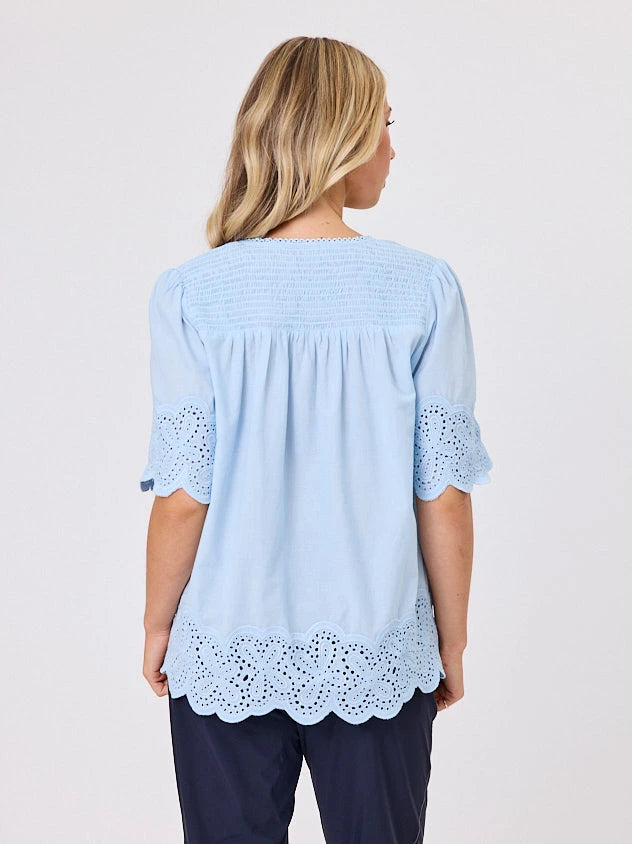 Woman standing front-on in studio light wearing pastel blue cotton top, by Navy & Co nz fashion brand 